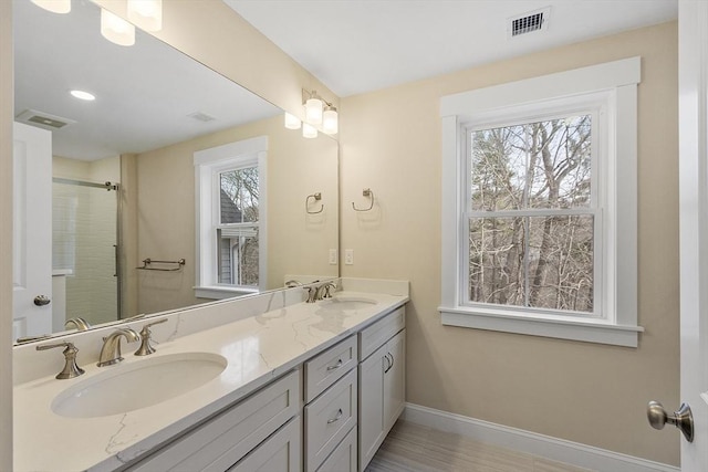 bathroom with visible vents, a wealth of natural light, and a sink