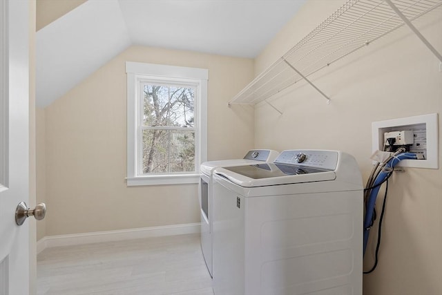 laundry room with light wood finished floors, baseboards, laundry area, and washer and clothes dryer