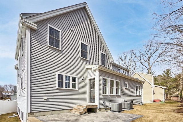 back of house featuring central air condition unit and fence