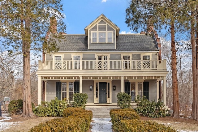 view of front of property featuring a balcony and covered porch