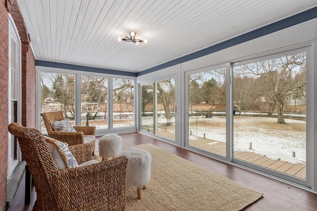 sunroom with a wealth of natural light and wood ceiling