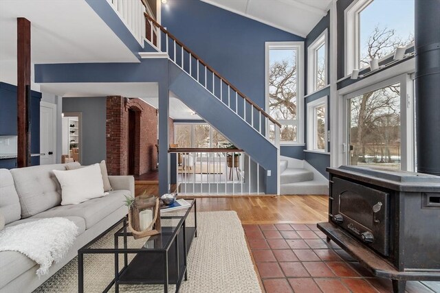 living room featuring vaulted ceiling, a wealth of natural light, and tile patterned floors