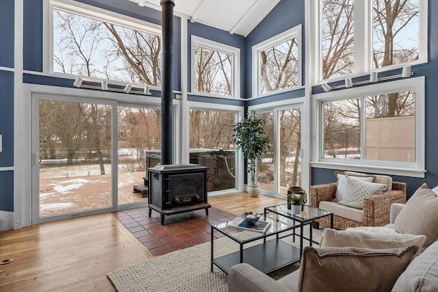 sunroom / solarium with plenty of natural light and a wood stove