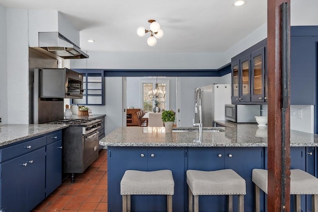 kitchen featuring blue cabinetry, appliances with stainless steel finishes, and a breakfast bar