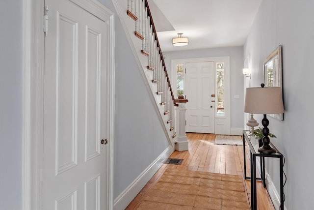 foyer with a wealth of natural light and light hardwood / wood-style flooring