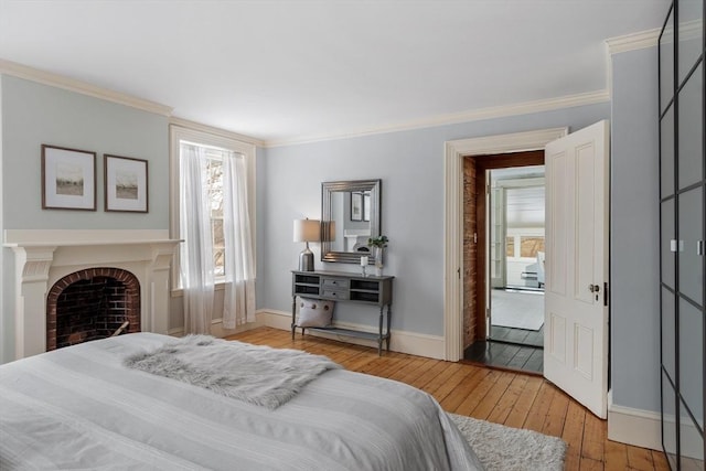 bedroom featuring light wood-type flooring and crown molding