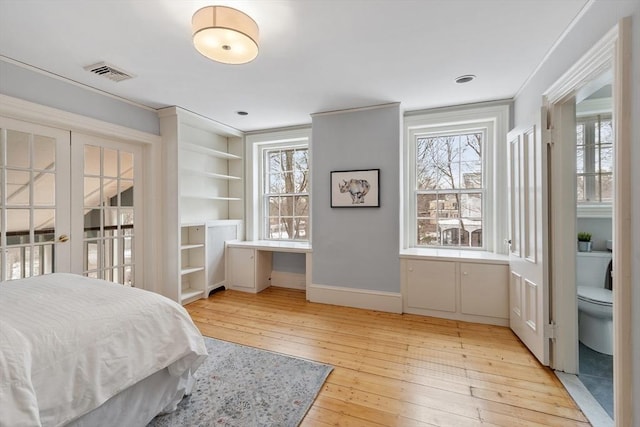 bedroom with light wood-type flooring and crown molding