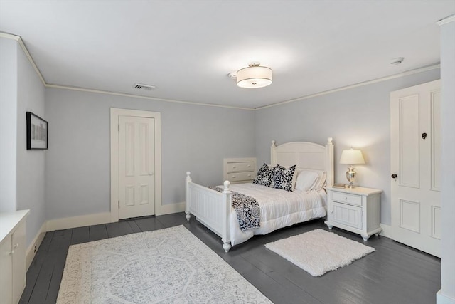 bedroom featuring ornamental molding and dark hardwood / wood-style flooring