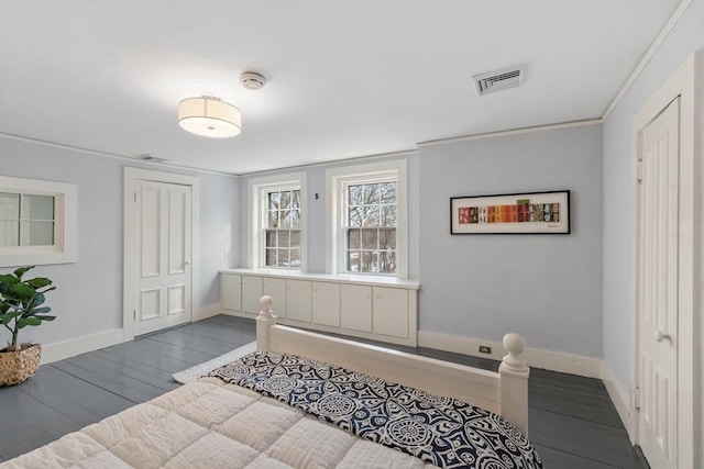 bedroom featuring a closet, hardwood / wood-style flooring, and ornamental molding