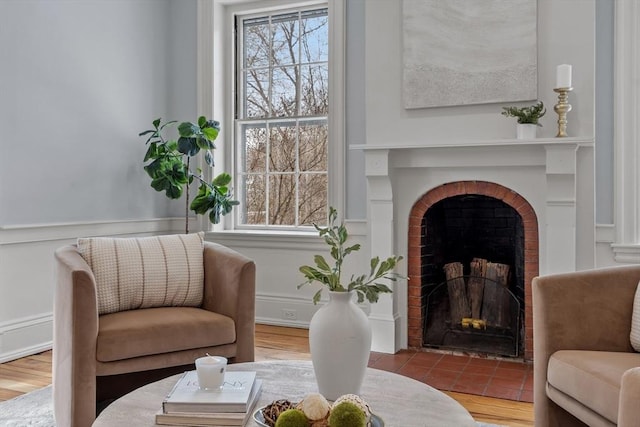 living area with a fireplace and a healthy amount of sunlight