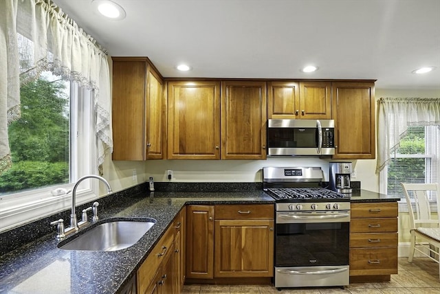 13 Delaval Rd, Worcester, MA 01606 - kitchen featuring appliances with stainless steel finishes, a sink, dark stone countertops, recessed lighting, and brown cabinetry