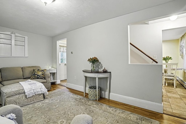 13 Delaval Rd, Worcester, MA 01606 - living area with wood finished floors, baseboards, and stairway