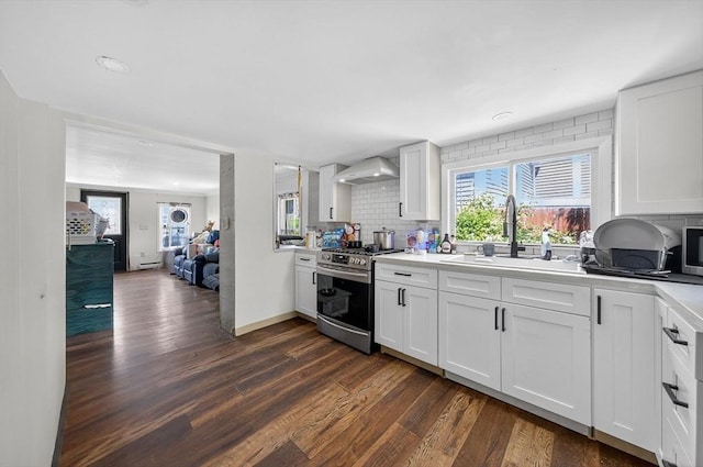 42 Mccabe St, Dartmouth, MA 02748 - kitchen featuring appliances with stainless steel finishes, dark wood finished floors, tasteful backsplash, wall chimney exhaust hood, and light countertops