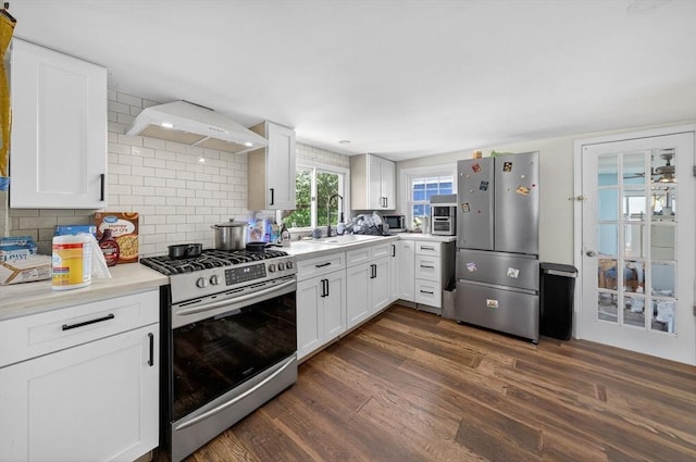 42 Mccabe St, Dartmouth, MA 02748 - kitchen featuring appliances with stainless steel finishes, custom exhaust hood, dark wood-style flooring, light countertops, and white cabinetry