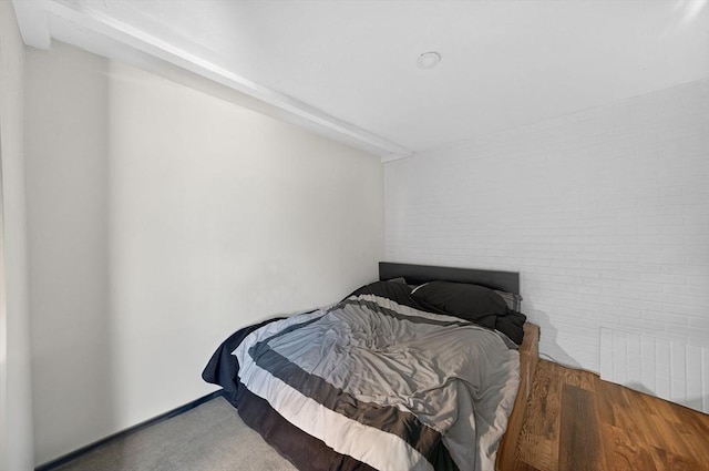 42 Mccabe St, Dartmouth, MA 02748 - bedroom with brick wall, radiator heating unit, and wood finished floors