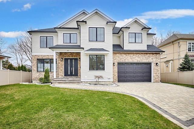 view of front of house featuring a front yard and a garage