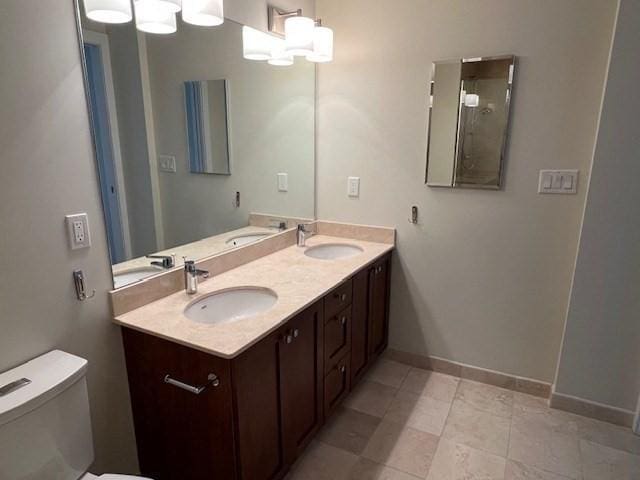 321 Hammond Pond Pkwy Unit U301, Brookline, MA 02467 - full bathroom featuring toilet, double vanity, baseboards, tile patterned flooring, and a chandelier