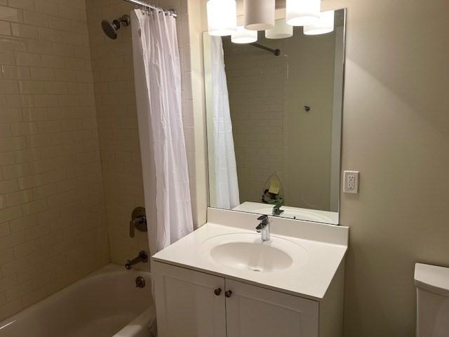 321 Hammond Pond Pkwy Unit U301, Brookline, MA 02467 - bathroom with shower / bath combo with shower curtain, toilet, and vanity