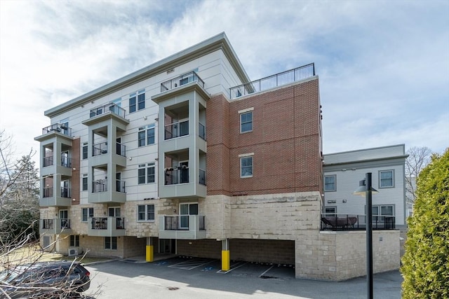 321 Hammond Pond Pkwy Unit U301, Brookline, MA 02467 - view of apartment building / complex with uncovered parking
