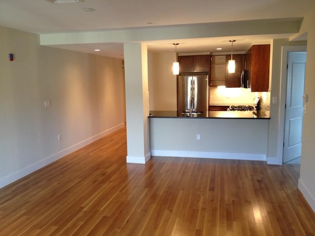 321 Hammond Pond Pkwy Unit U301, Brookline, MA 02467 - kitchen featuring stainless steel appliances, dark countertops, wood finished floors, and baseboards