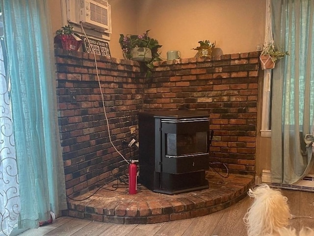 16 Heather Ln Unit 16, Bridgewater, MA 02324 - detailed view of wood finished floors, a wall mounted air conditioner, a baseboard heating unit, and a wood stove