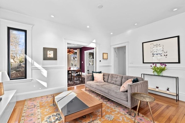 living area featuring recessed lighting, baseboards, and wood finished floors