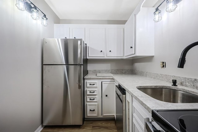 kitchen with sink, stainless steel appliances, and white cabinets