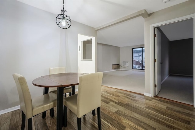 dining room with wood-type flooring and a wall mounted air conditioner