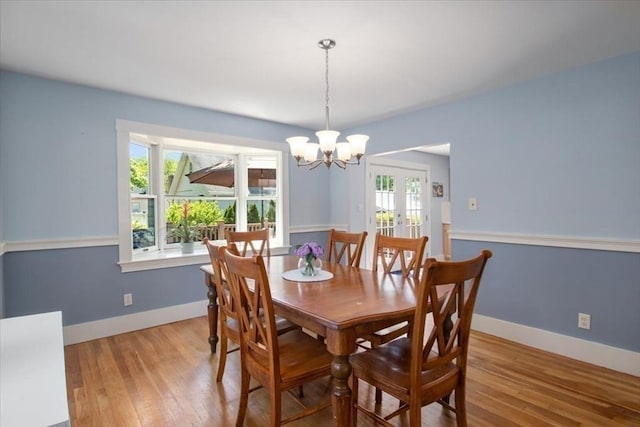 127 Mutton Ln, Weymouth, MA 02189 - dining area featuring wood finished floors, french doors, a chandelier, and baseboards
