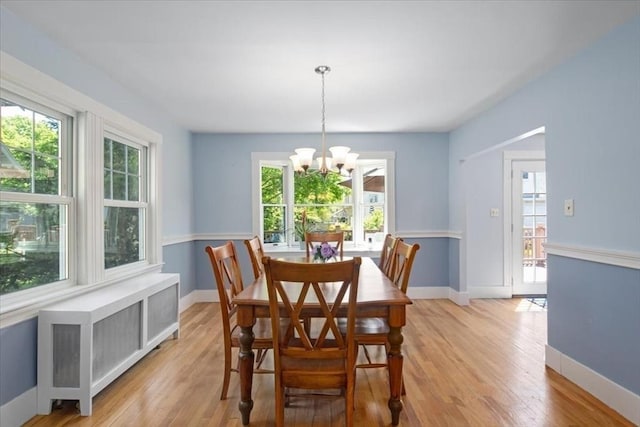 127 Mutton Ln, Weymouth, MA 02189 - dining room with a chandelier, healthy amount of natural light, light wood-style floors, and baseboards