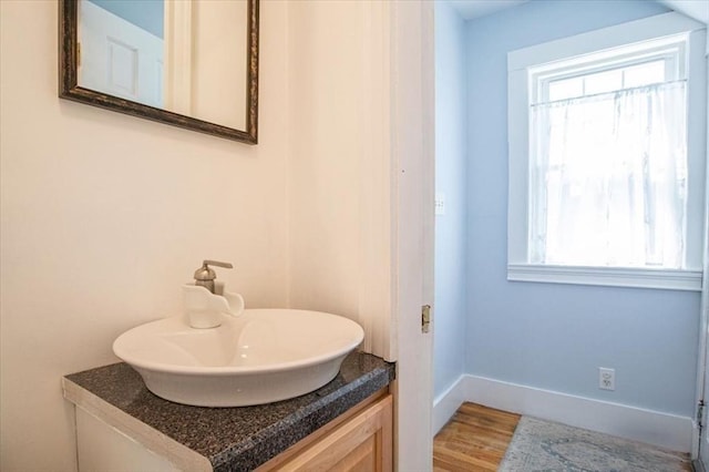 127 Mutton Ln, Weymouth, MA 02189 - bathroom featuring healthy amount of natural light, baseboards, vanity, and wood finished floors