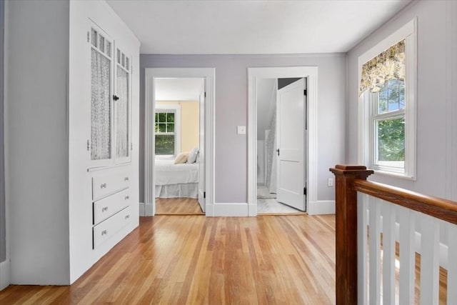 127 Mutton Ln, Weymouth, MA 02189 - hallway with light wood-type flooring, baseboards, and an upstairs landing