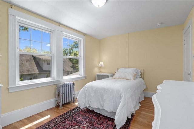127 Mutton Ln, Weymouth, MA 02189 - bedroom featuring radiator, wood finished floors, and baseboards