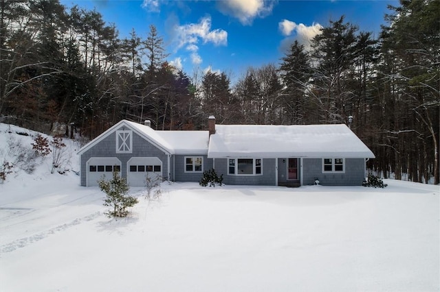 ranch-style home with a garage and a chimney