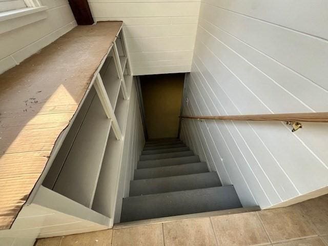 staircase featuring tile patterned floors