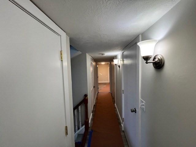 hallway featuring a textured ceiling