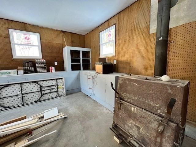 miscellaneous room featuring a healthy amount of sunlight and unfinished concrete floors