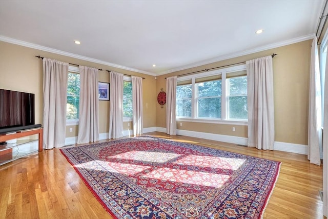 living room featuring ornamental molding and light hardwood / wood-style floors