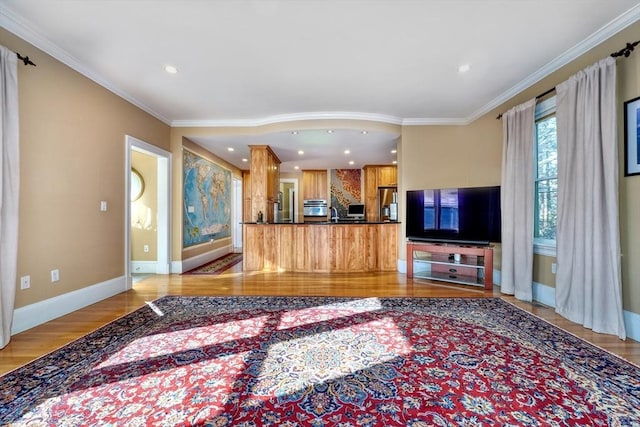 living room featuring ornamental molding and light hardwood / wood-style flooring