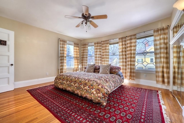 bedroom with hardwood / wood-style flooring and ceiling fan