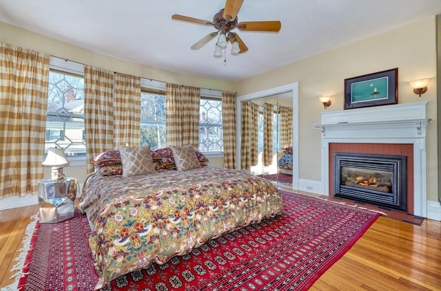 bedroom featuring ceiling fan, wood-type flooring, and a closet