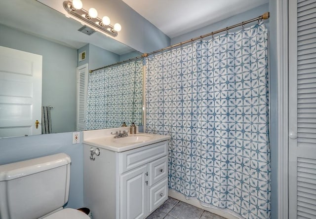 bathroom with vanity, tile patterned floors, and toilet