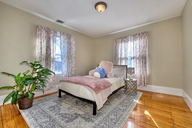 bedroom with hardwood / wood-style flooring