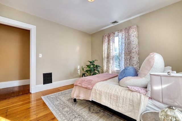 bedroom with hardwood / wood-style floors