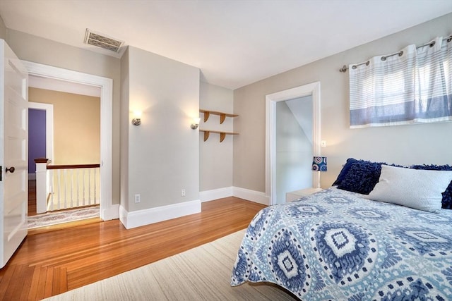 bedroom with hardwood / wood-style floors