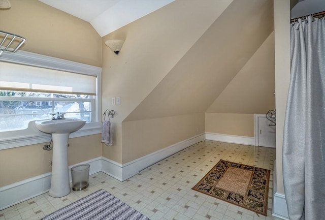 bathroom with lofted ceiling and sink