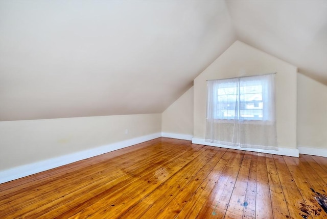 bonus room featuring lofted ceiling and wood-type flooring