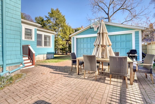 view of patio / terrace with a garage and an outdoor structure