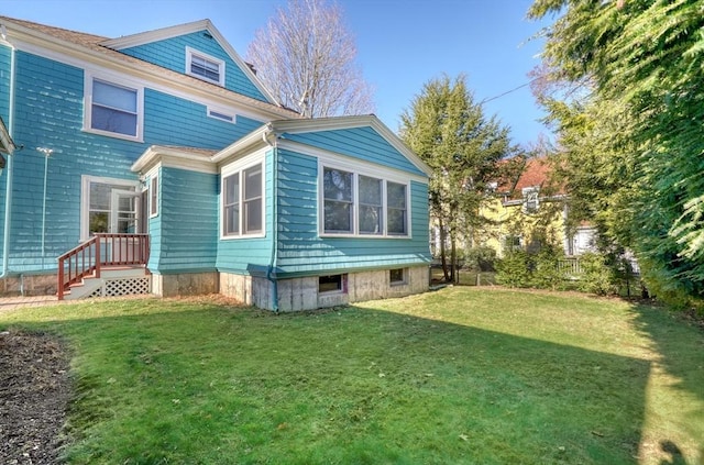 rear view of house with a yard