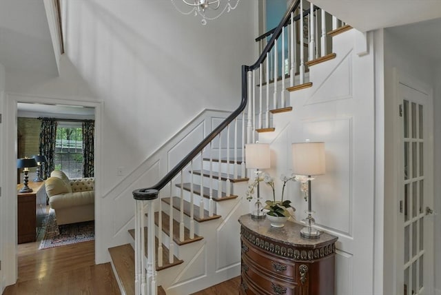 11 Edge Hill Rd, Hopkinton, MA 01748 - staircase featuring wood finished floors, a towering ceiling, and a chandelier